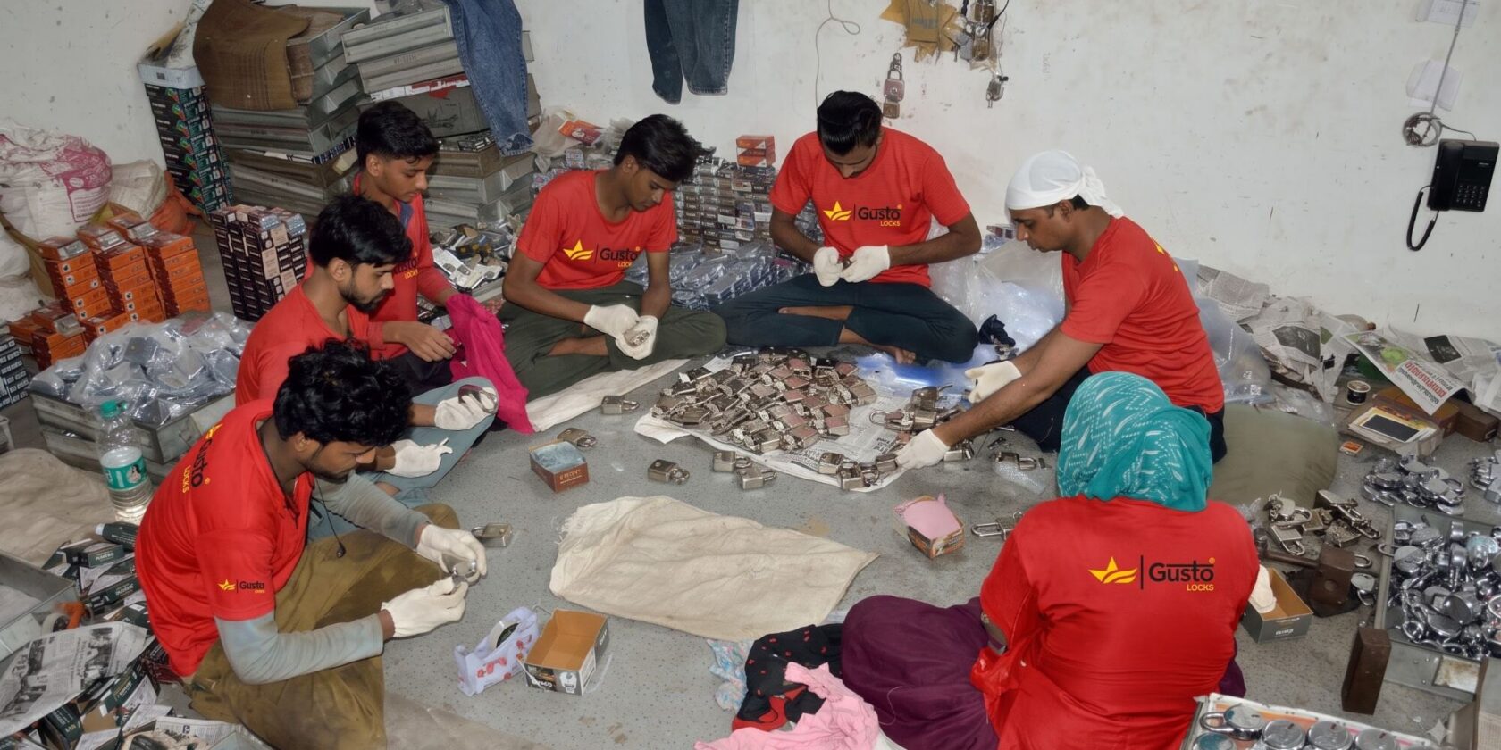 The assembly team in Gusto Locks uniform sorting and packing finished padlocks