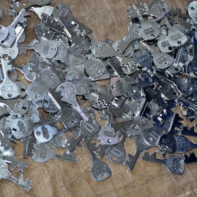 A pile of cut and stamped Gusto padlock keys